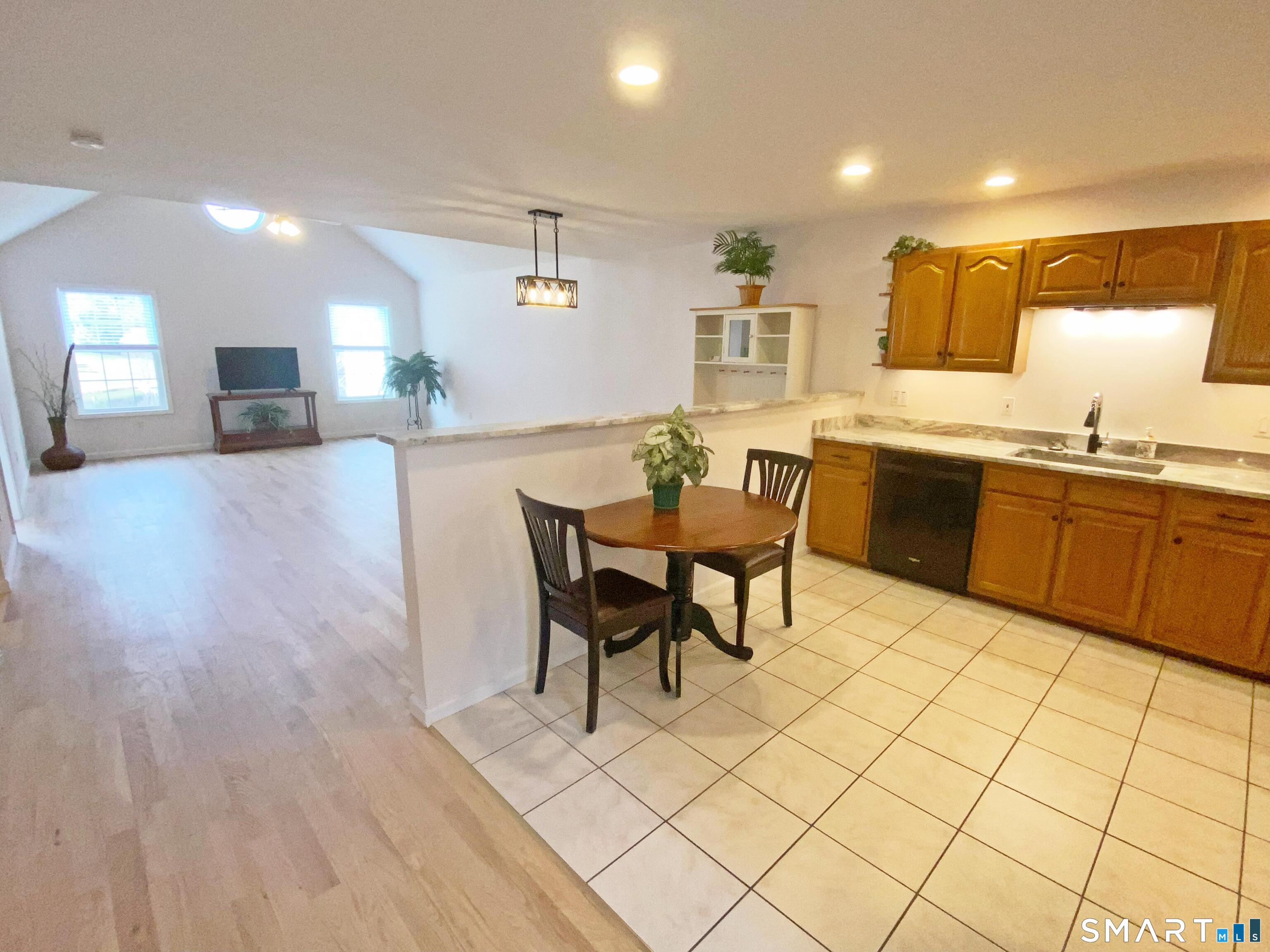 8 St George Place, Unit 8 Newtown, CT 06482 - Photo 30 of 31 a large kitchen with a table and chairs in it