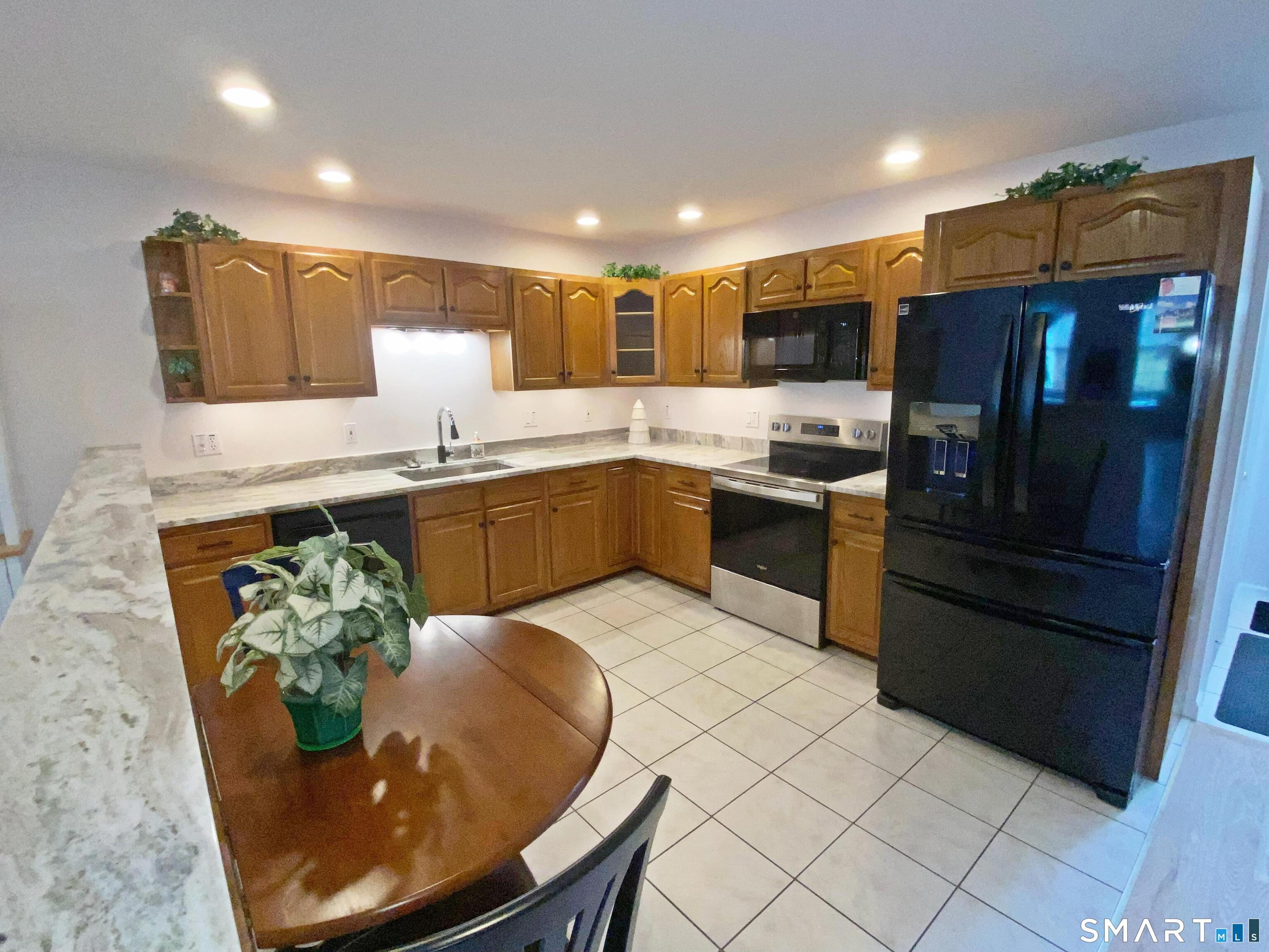 8 St George Place, Unit 8 Newtown, CT 06482 - Photo 7 of 31 a kitchen with stainless steel appliances granite countertop a sink and a refrigerator