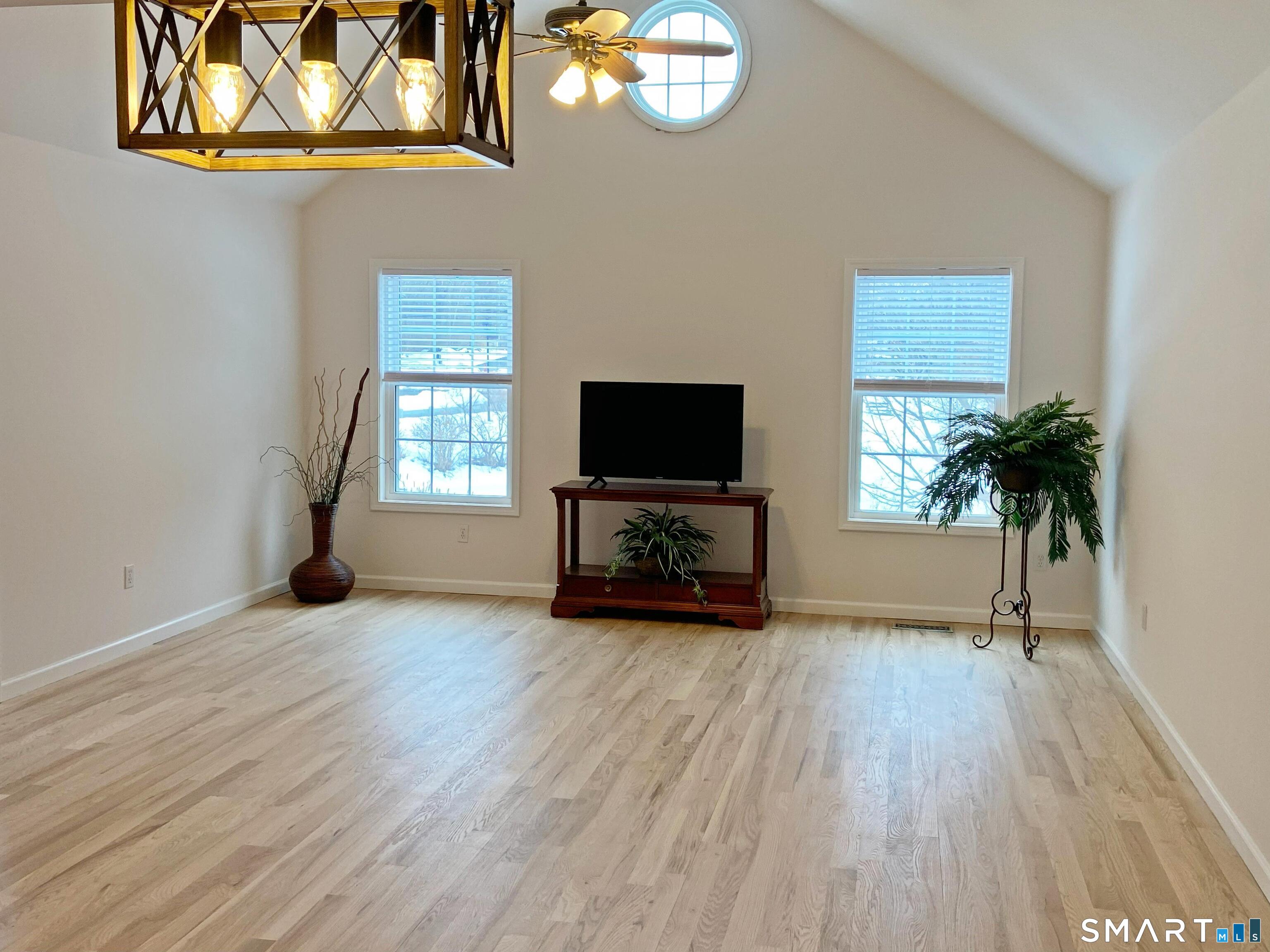 8 St George Place, Unit 8 Newtown, CT 06482 - Photo 31 of 31 Open floor plan great room with living and dining areas, window views to pond