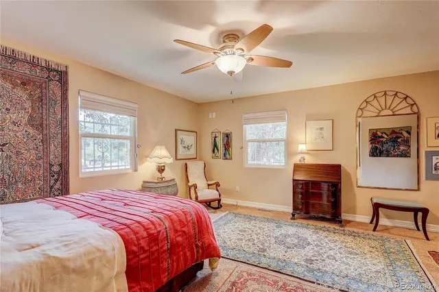 a bedroom with a bed and dresser with mirror