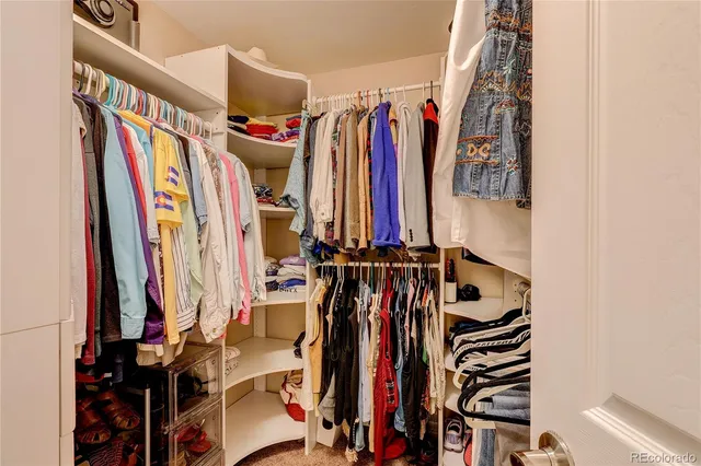 a view of walk in closet with clothes