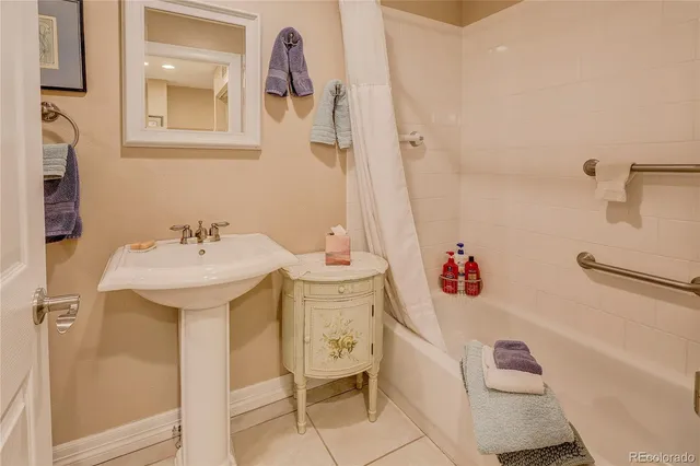 a bathroom with a sink mirror and tub