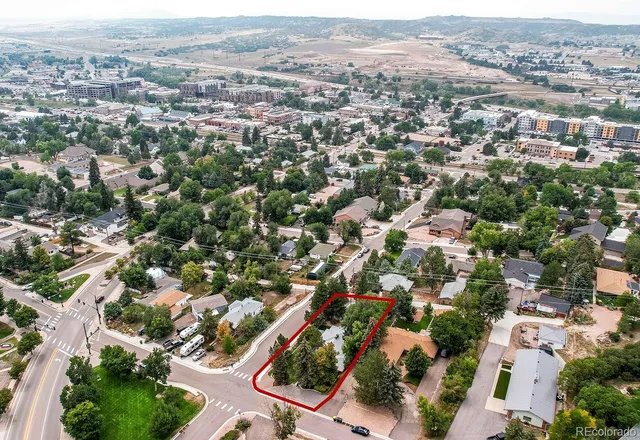 an aerial view of residential houses with city view