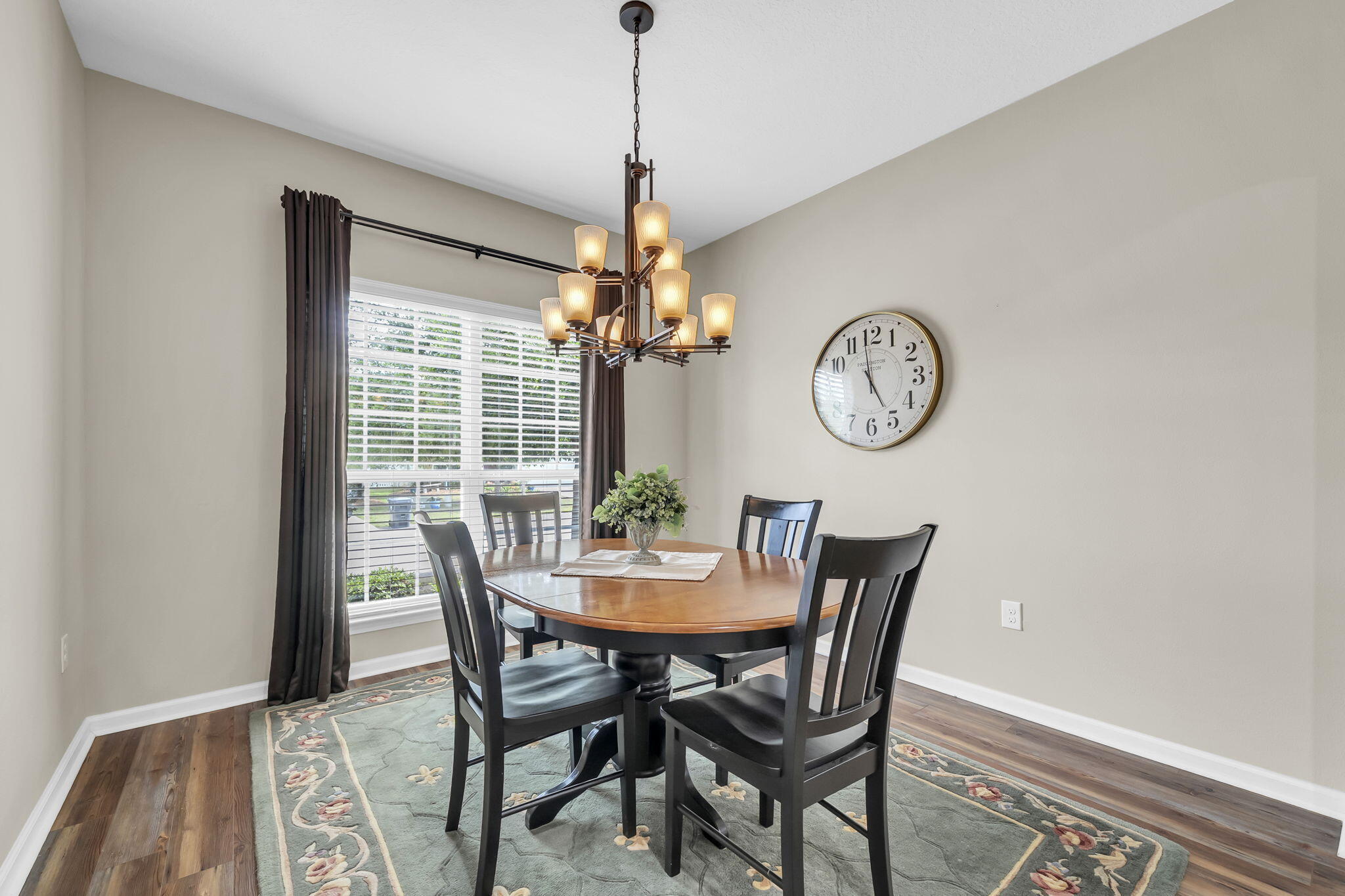 115 Lilly Bell Lane Freeport, FL 32439 - Photo 12 of 47 a dining room with furniture a chandelier and a rug