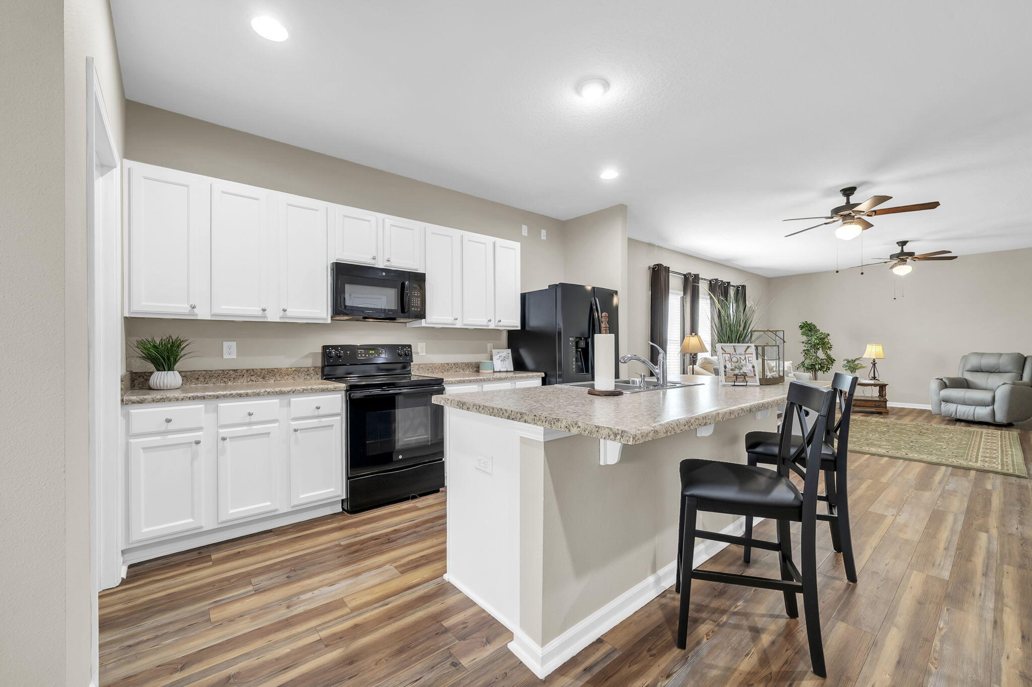 115 Lilly Bell Lane Freeport, FL 32439 - Photo 13 of 47 a kitchen with a table chairs refrigerator and cabinets