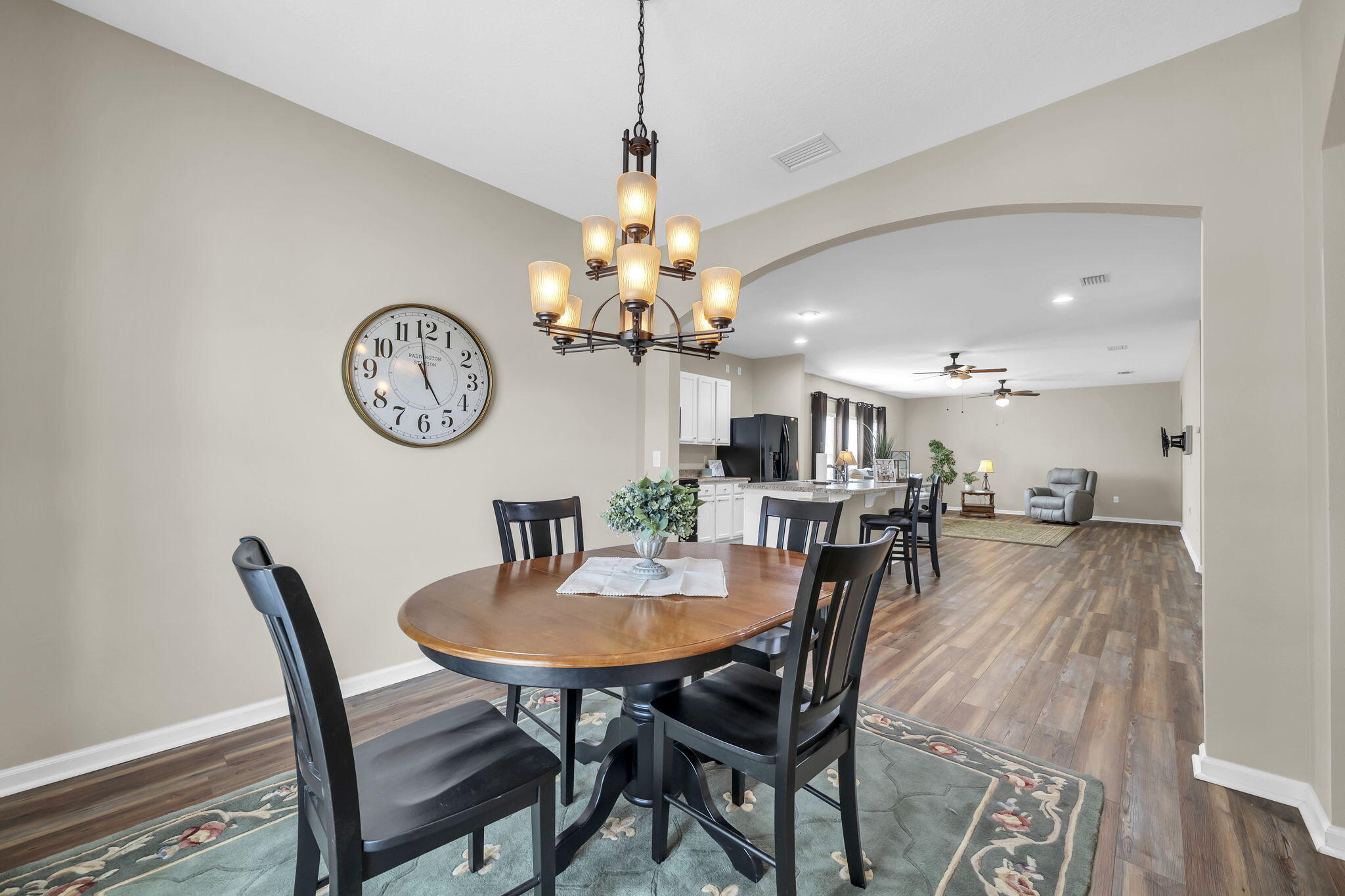 115 Lilly Bell Lane Freeport, FL 32439 - Photo 2 of 47 a dining room with furniture and a clock