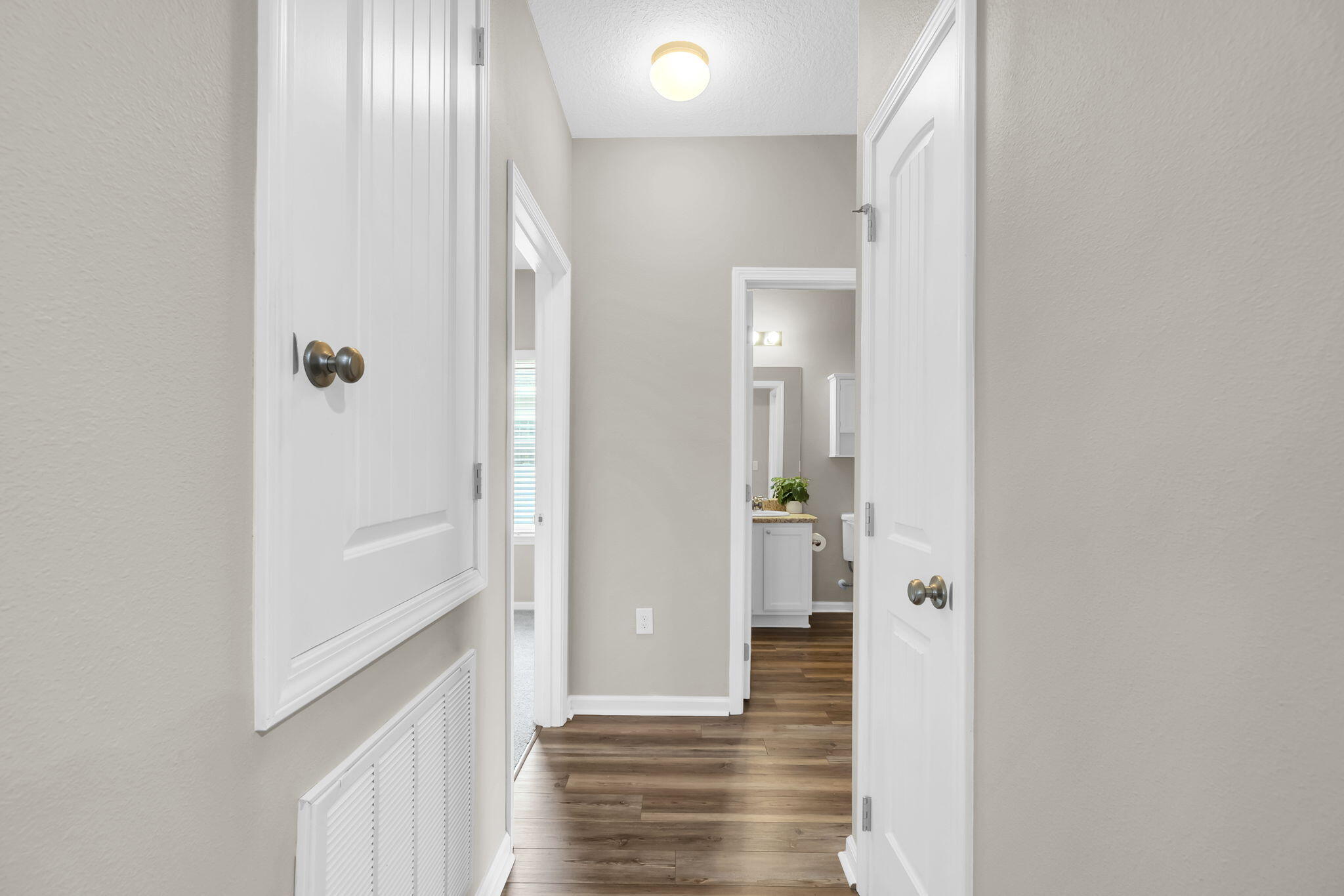 115 Lilly Bell Lane Freeport, FL 32439 - Photo 23 of 47 a view of a hallway with wooden floor and closet area