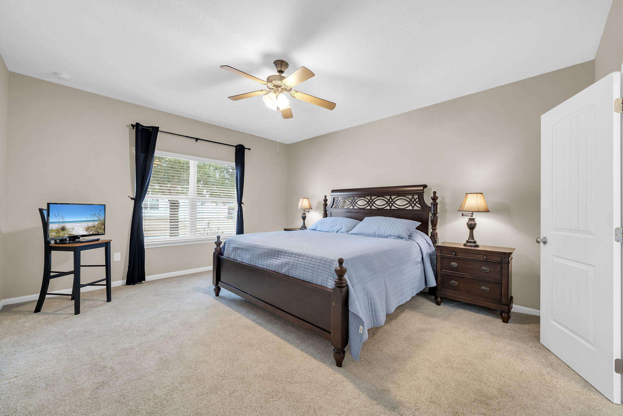 115 Lilly Bell Lane Freeport, FL 32439 - Photo 29 of 47 a bedroom with a bed and a chandelier
