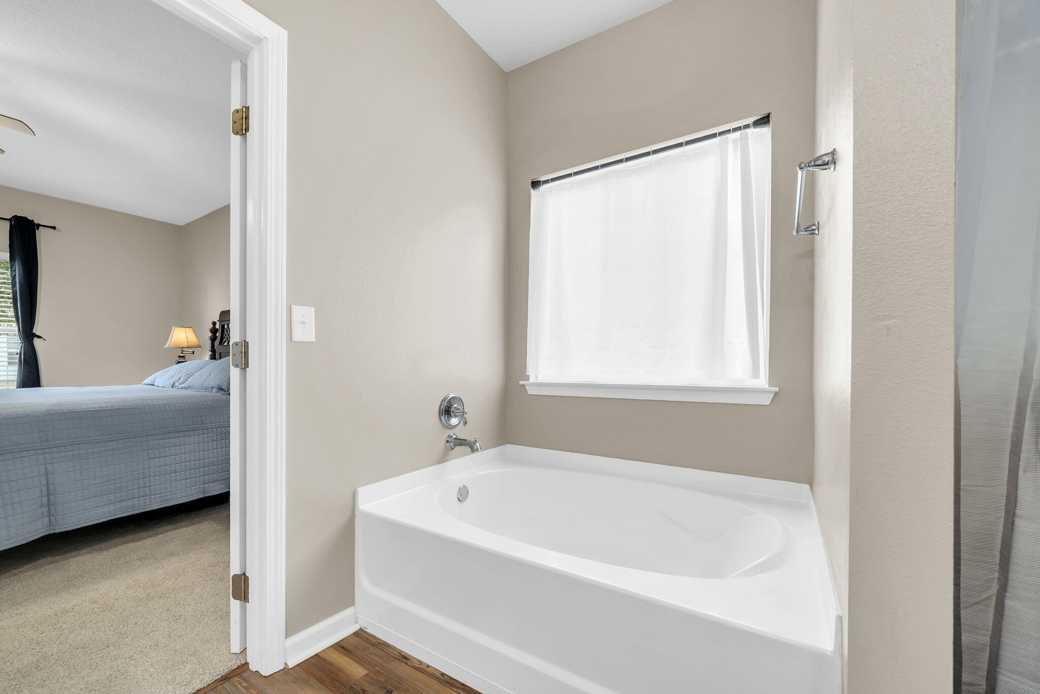 115 Lilly Bell Lane Freeport, FL 32439 - Photo 33 of 47 a en suite bathroom with a bathtub and window