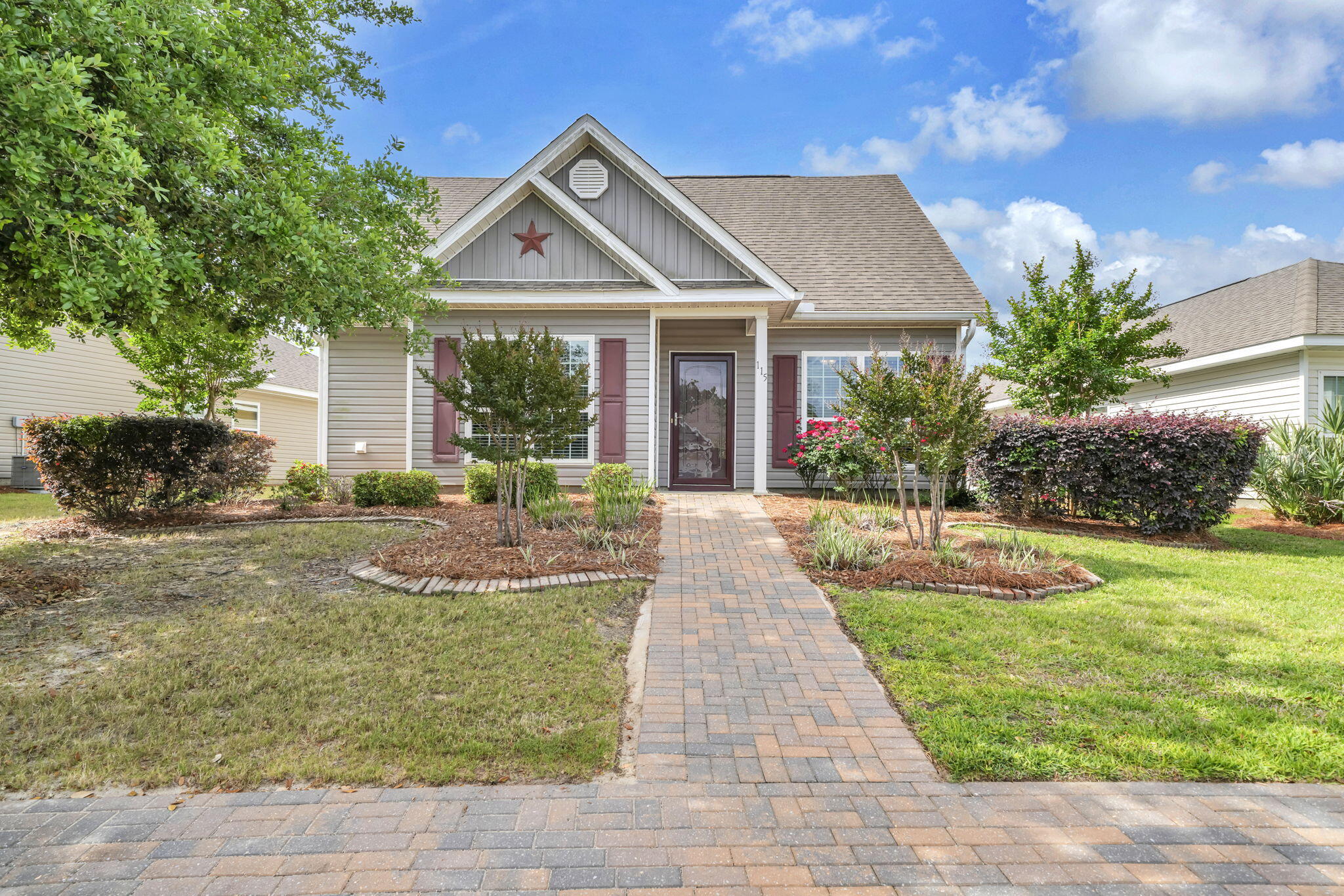 115 Lilly Bell Lane Freeport, FL 32439 - Photo 7 of 47 a front view of a house with garden