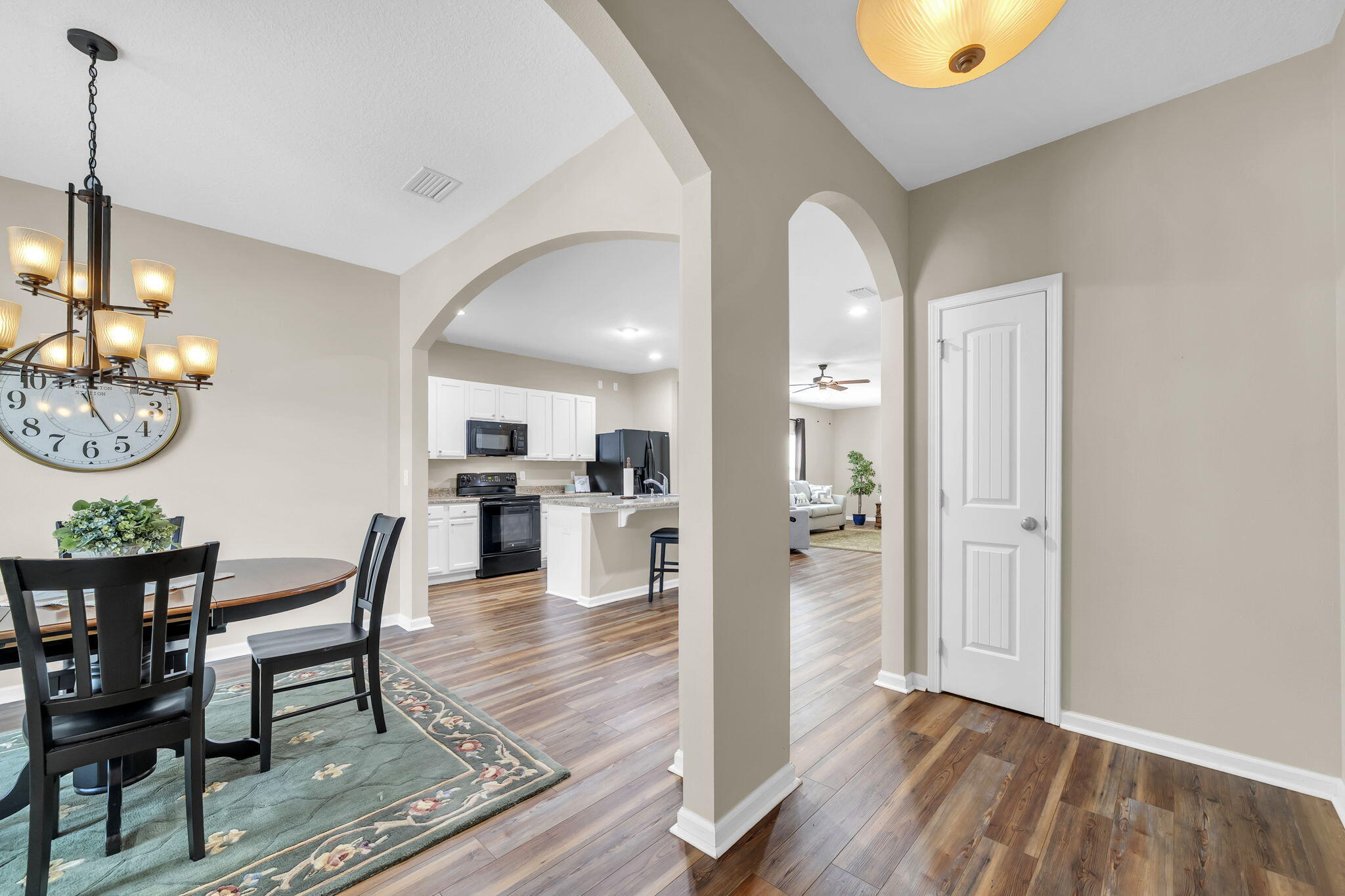 115 Lilly Bell Lane Freeport, FL 32439 - Photo 10 of 47 a view of a dining room and livingroom with furniture wooden floor a chandelier
