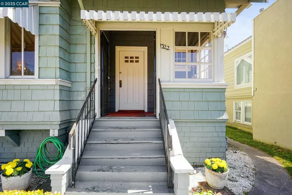 a front view of a house with outdoor seating