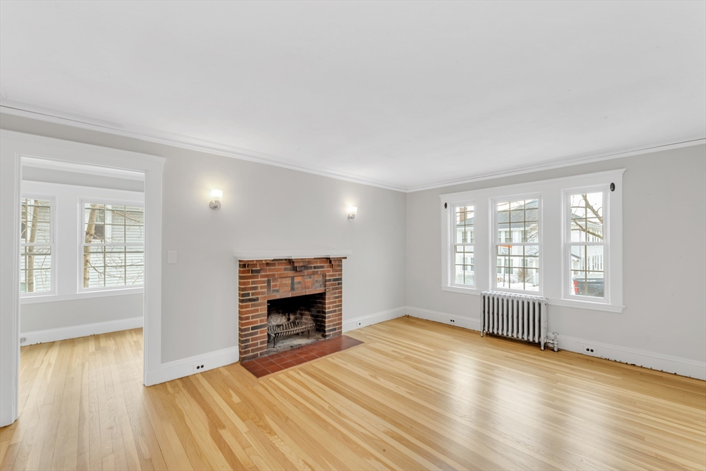 21-23 Richards Road, Unit 21 Watertown, MA 02472 - Photo 11 of 28 an empty room with windows and fireplace