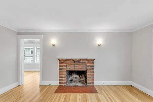 a room with a fireplace and wooden floor