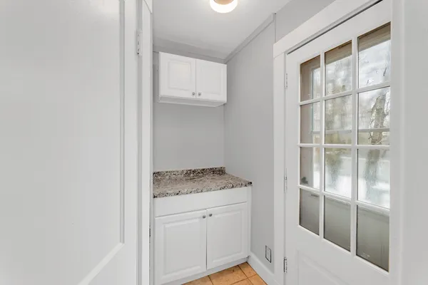 a view of bathroom with granite countertop cabinets