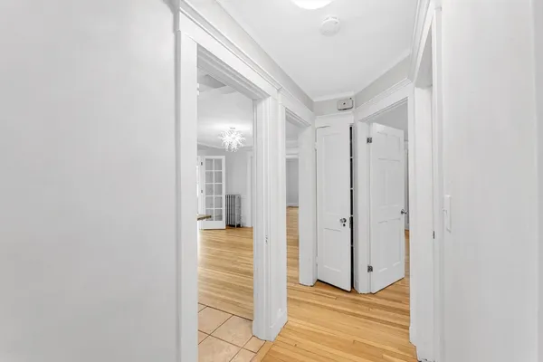 a view of a hallway with wooden floor and staircase
