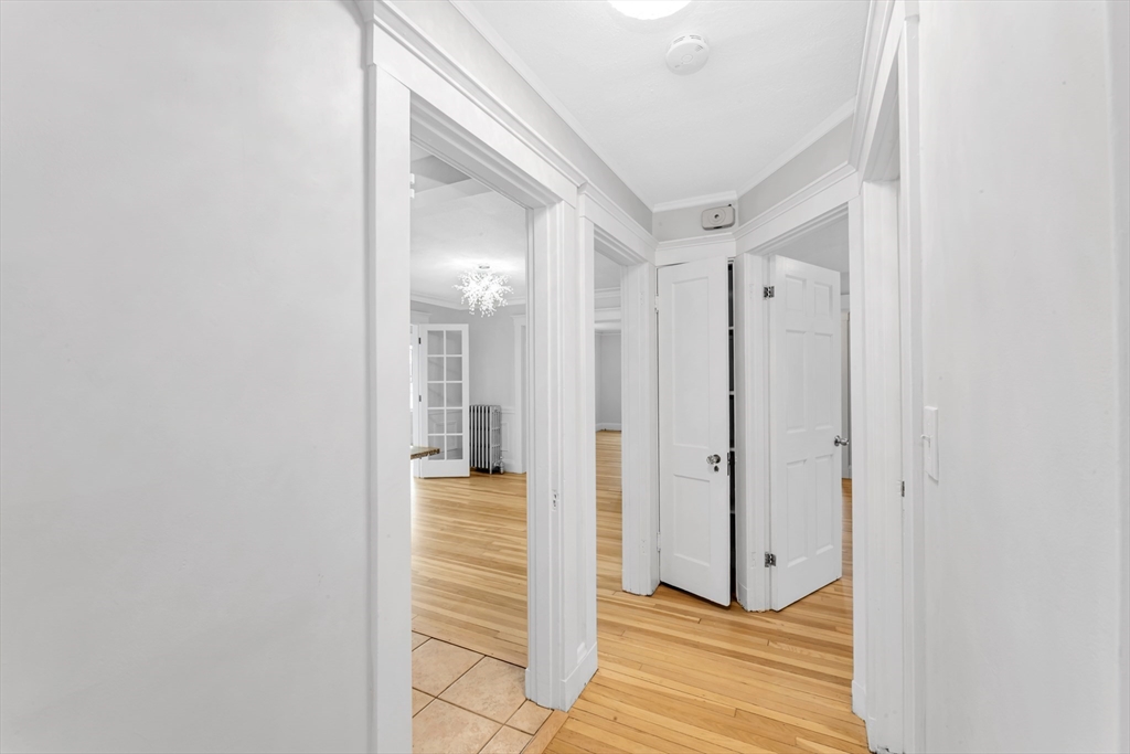 21-23 Richards Road, Unit 21 Watertown, MA 02472 - Photo 16 of 28 a view of a hallway with wooden floor and staircase