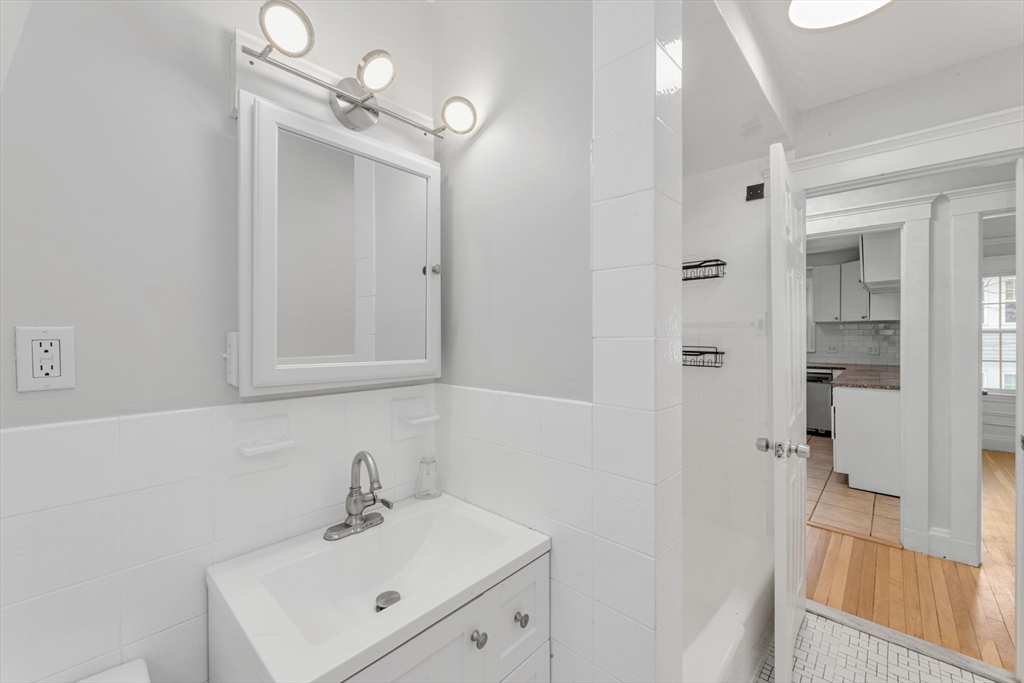 21-23 Richards Road, Unit 21 Watertown, MA 02472 - Photo 18 of 28 a bathroom with a sink a mirror and shower