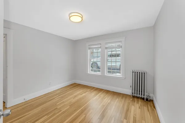 a view of wooden floor and windows in a room