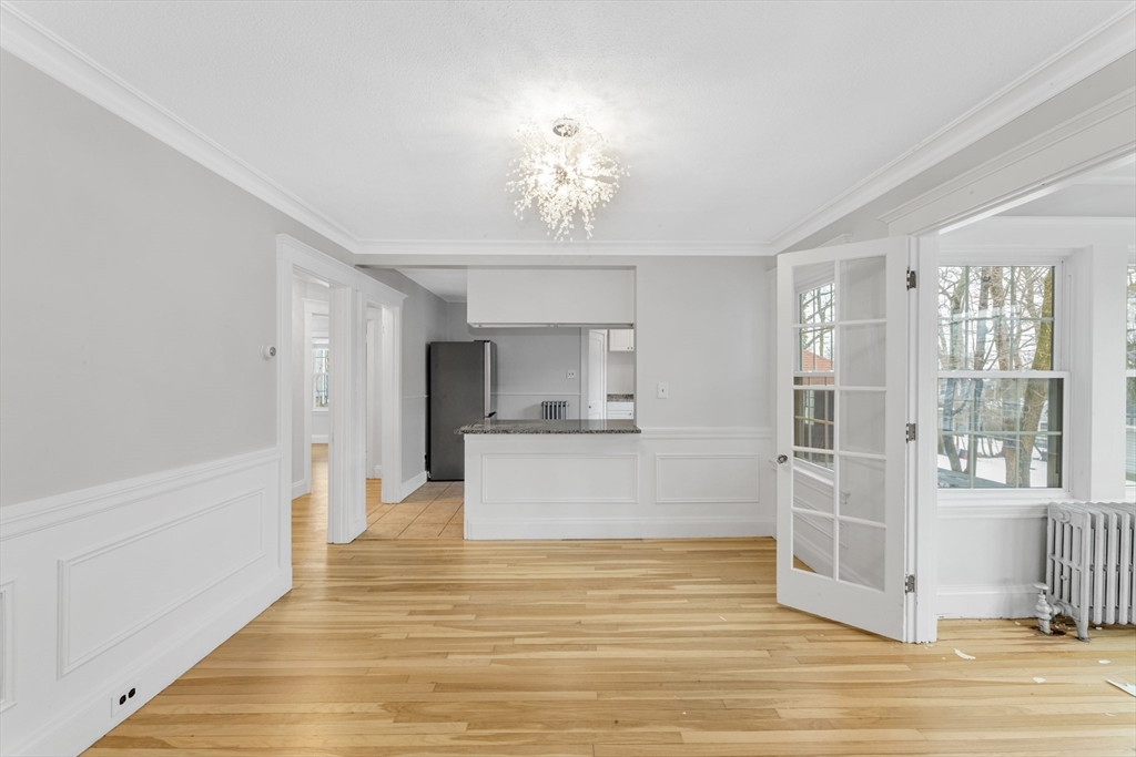21-23 Richards Road, Unit 21 Watertown, MA 02472 - Photo 2 of 28 a view of a living room with hardwood floor and a ceiling fan