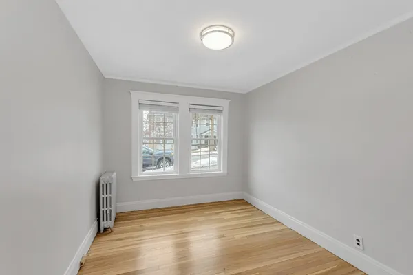 a view of a room with wooden floor