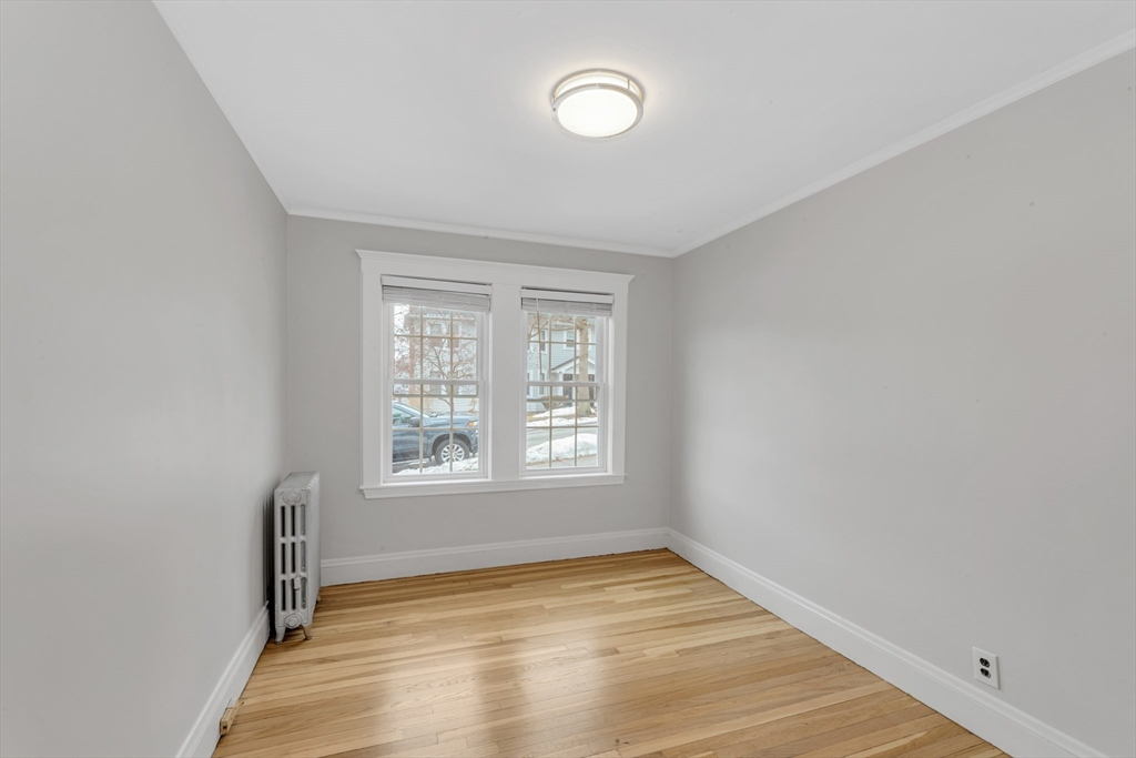 21-23 Richards Road, Unit 21 Watertown, MA 02472 - Photo 22 of 28 a view of an empty room with wooden floor and a window