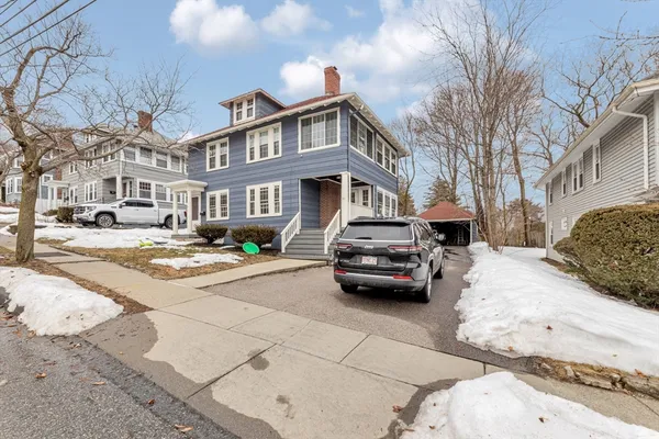 a view of a house with a yard and a garage