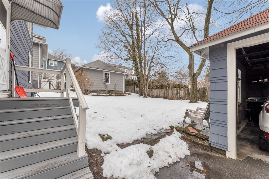 21-23 Richards Road, Unit 21 Watertown, MA 02472 - Photo 27 of 28 a view of a house with a snow in the yard