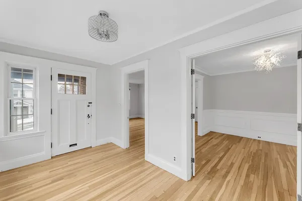 a view of a room with wooden floor and a bathroom