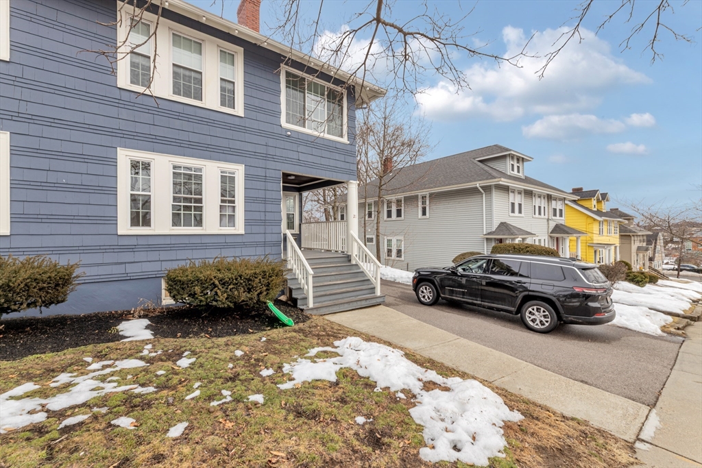 21-23 Richards Road, Unit 21 Watertown, MA 02472 - Photo 6 of 28 a car parked in front of a brick house