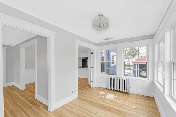 a view of a room with wooden floor and windows