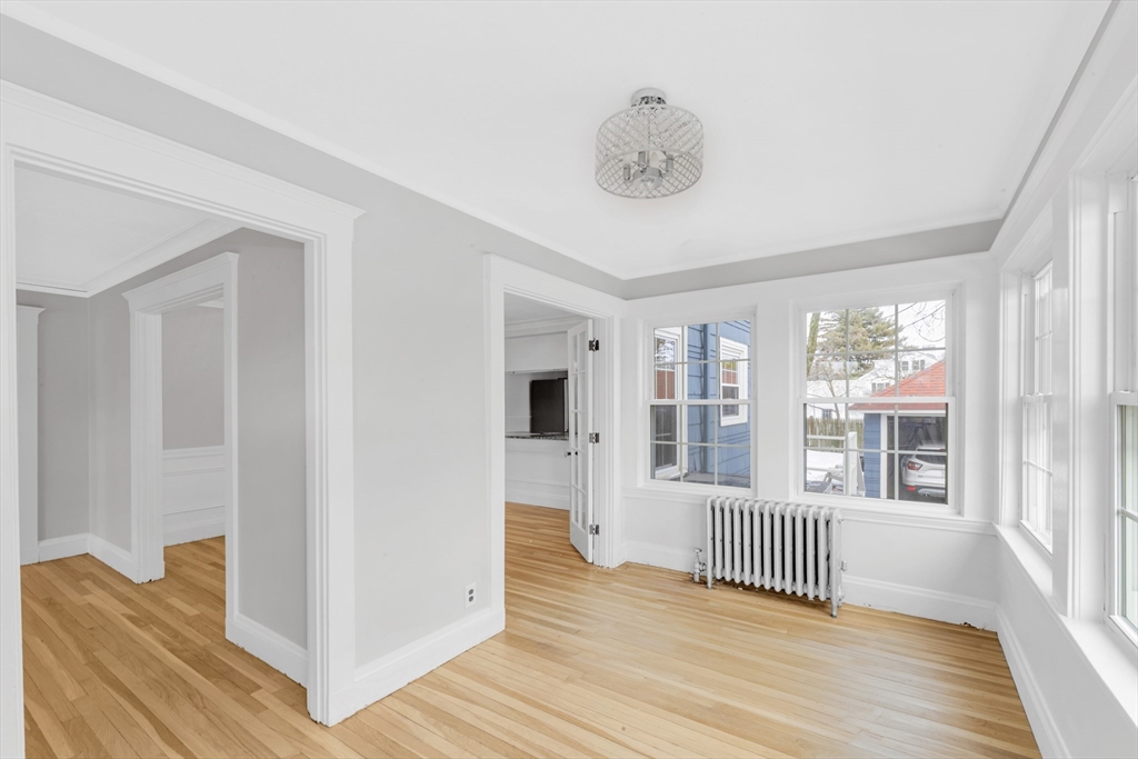 21-23 Richards Road, Unit 21 Watertown, MA 02472 - Photo 9 of 28 a view of a livingroom with wooden floor and a window