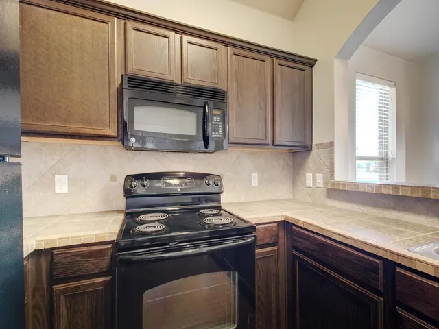 a kitchen with a stove and a microwave