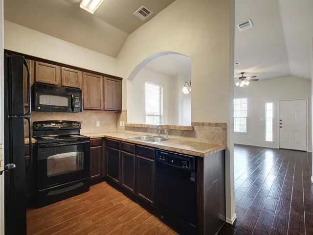 a kitchen with stainless steel appliances granite countertop a stove and a sink