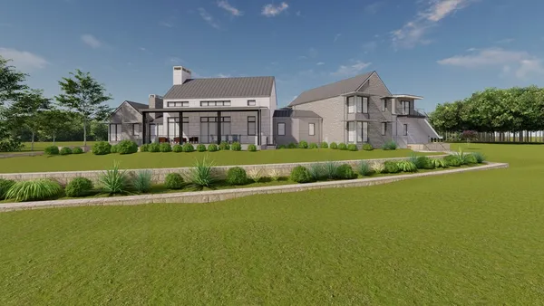 a view of a house next to a big yard with plants and large trees