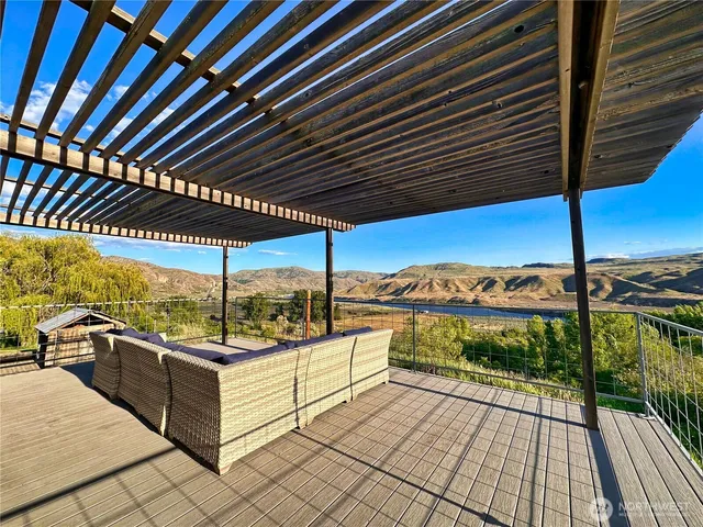 a view of a house with backyard and sitting area