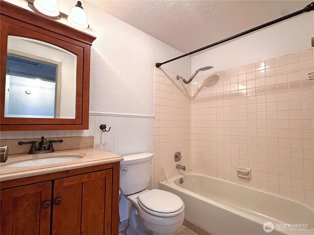 an empty room with fireplace and windows