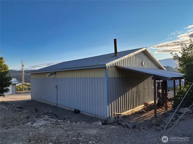 a view of a swimming pool with a table and chairs under an umbrella