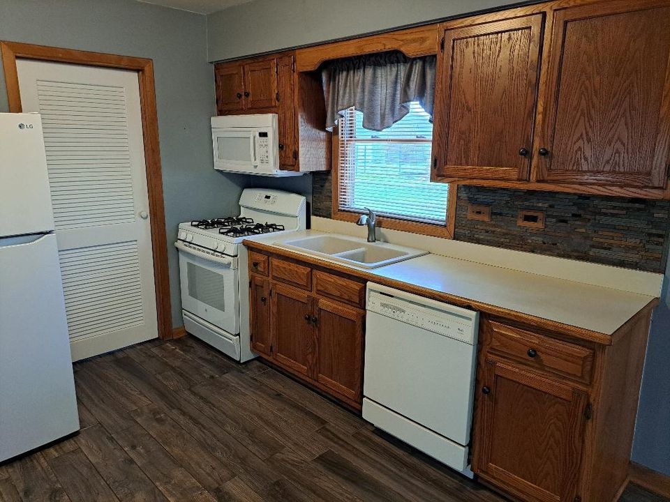 9155 Kings Road Morris, IL 60450 - Photo 7 of 15 a kitchen with stainless steel appliances a sink cabinets and wooden floor