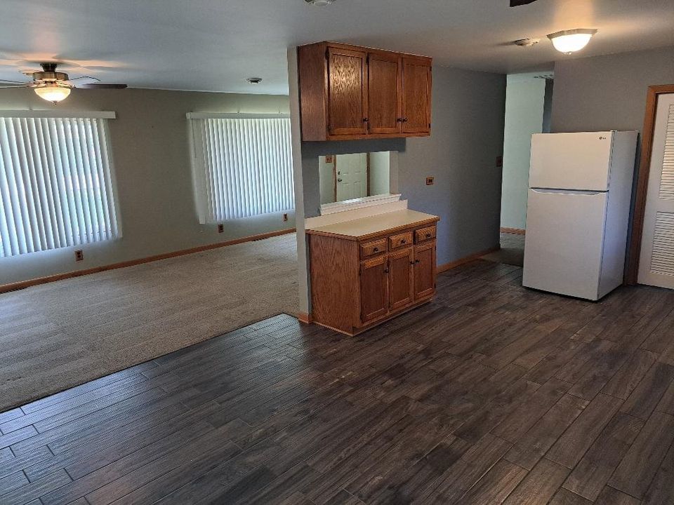 9155 Kings Road Morris, IL 60450 - Photo 8 of 15 a kitchen with granite countertop wooden floor a refrigerator a sink and dishwasher