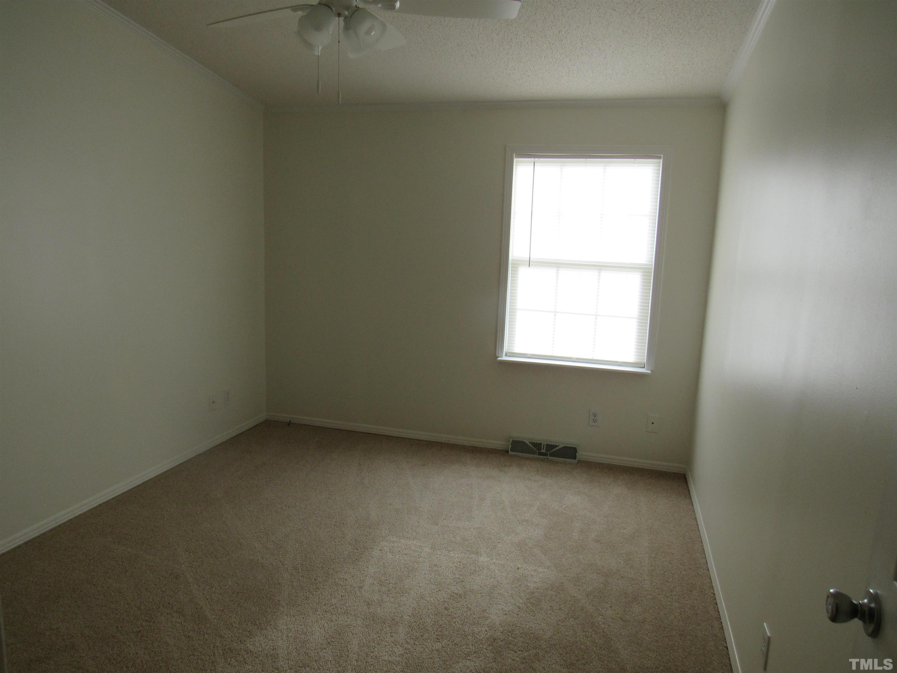 7816 Huff Farm Road Willow Spring, NC 27592 - Photo 17 of 25 an empty room with a window