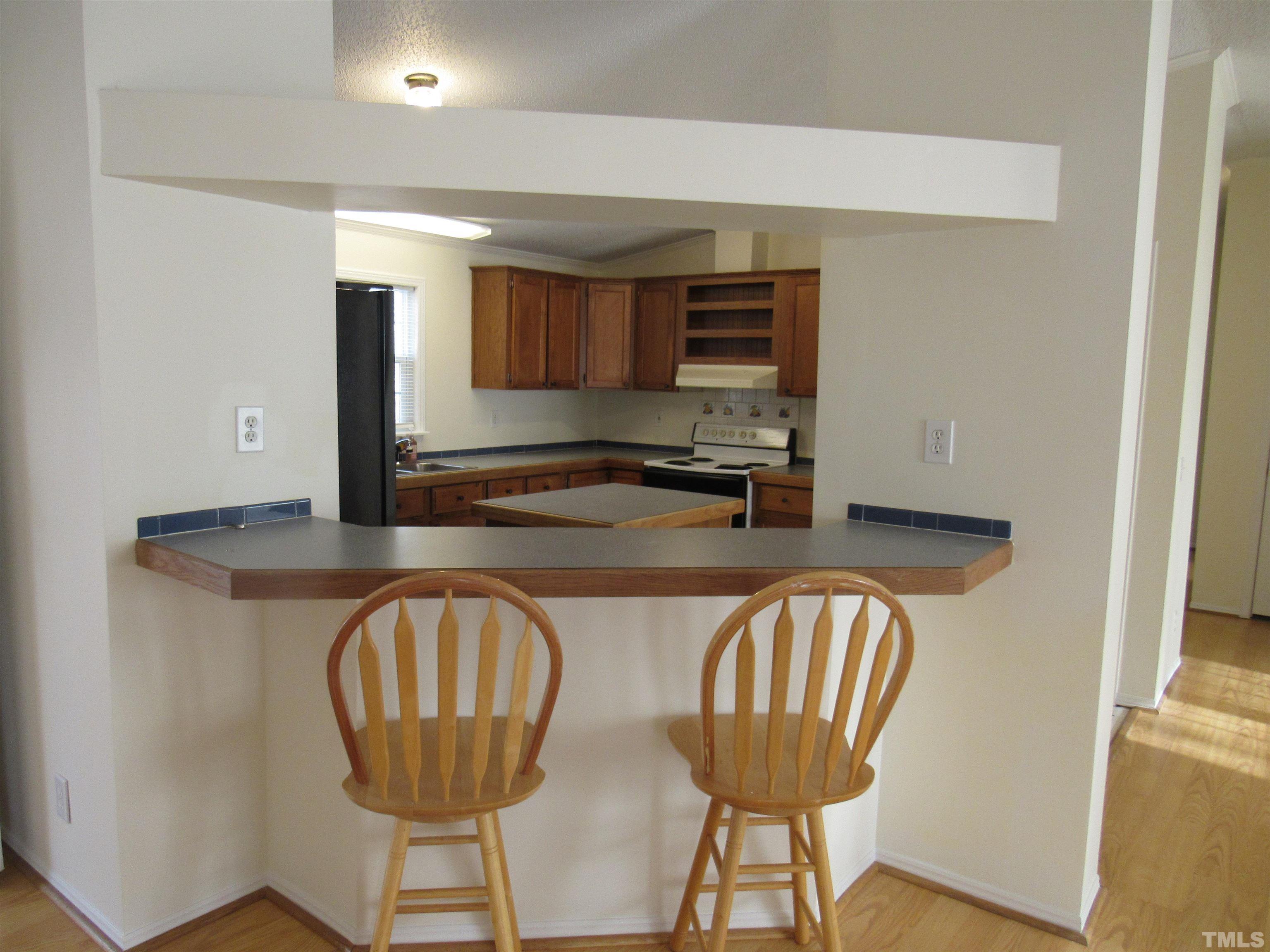 7816 Huff Farm Road Willow Spring, NC 27592 - Photo 9 of 25 a kitchen with stainless steel appliances granite countertop a table chairs in it and a window
