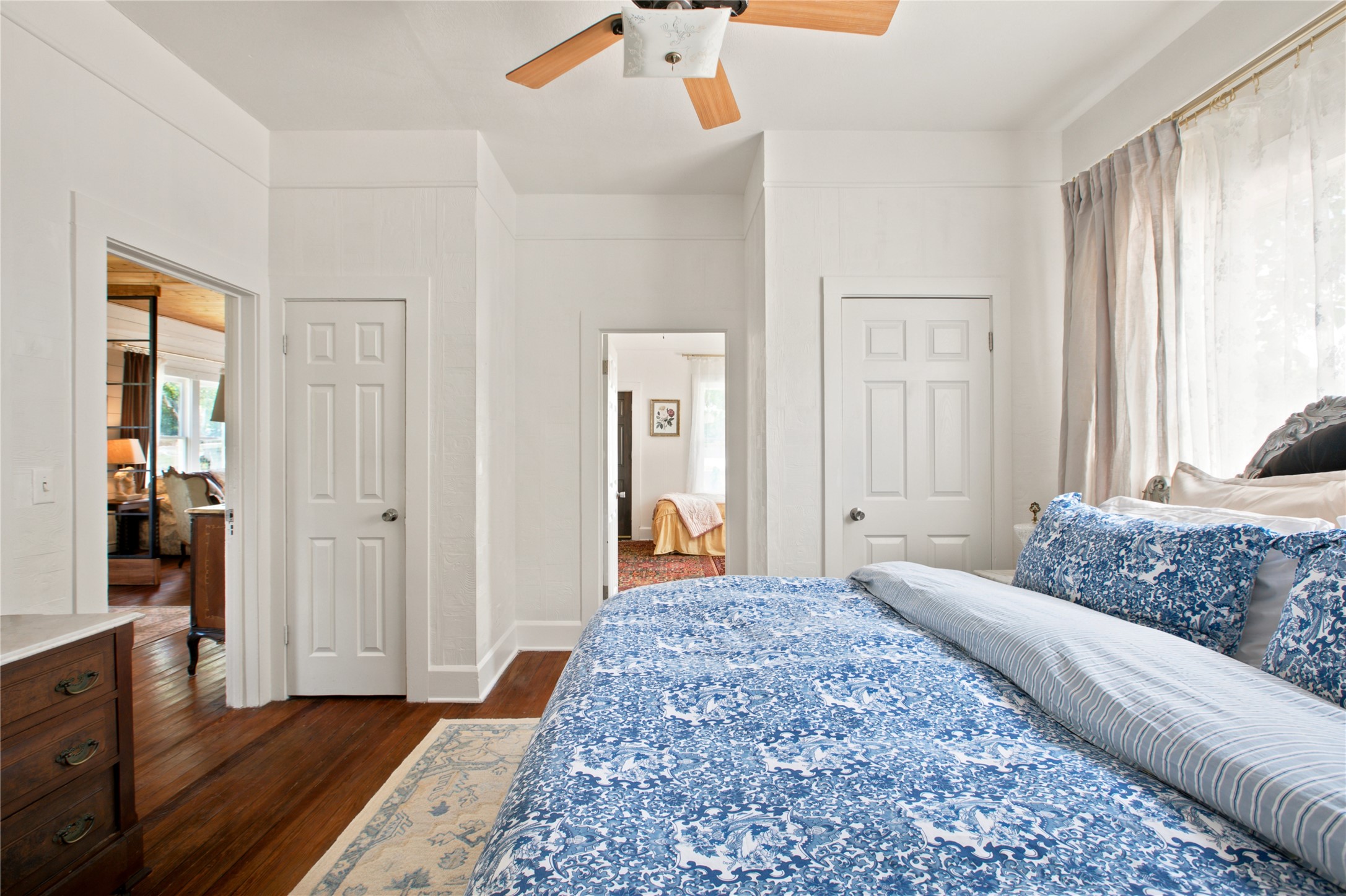 372 Old Lockhart Road Lockhart, TX 78644 - Photo 21 of 40 Hardwood floors and bright walls define this inviting bedroom, connecting seamlessly to other living spaces.
