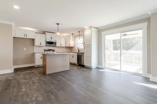 a kitchen with stainless steel appliances a refrigerator sink and microwave