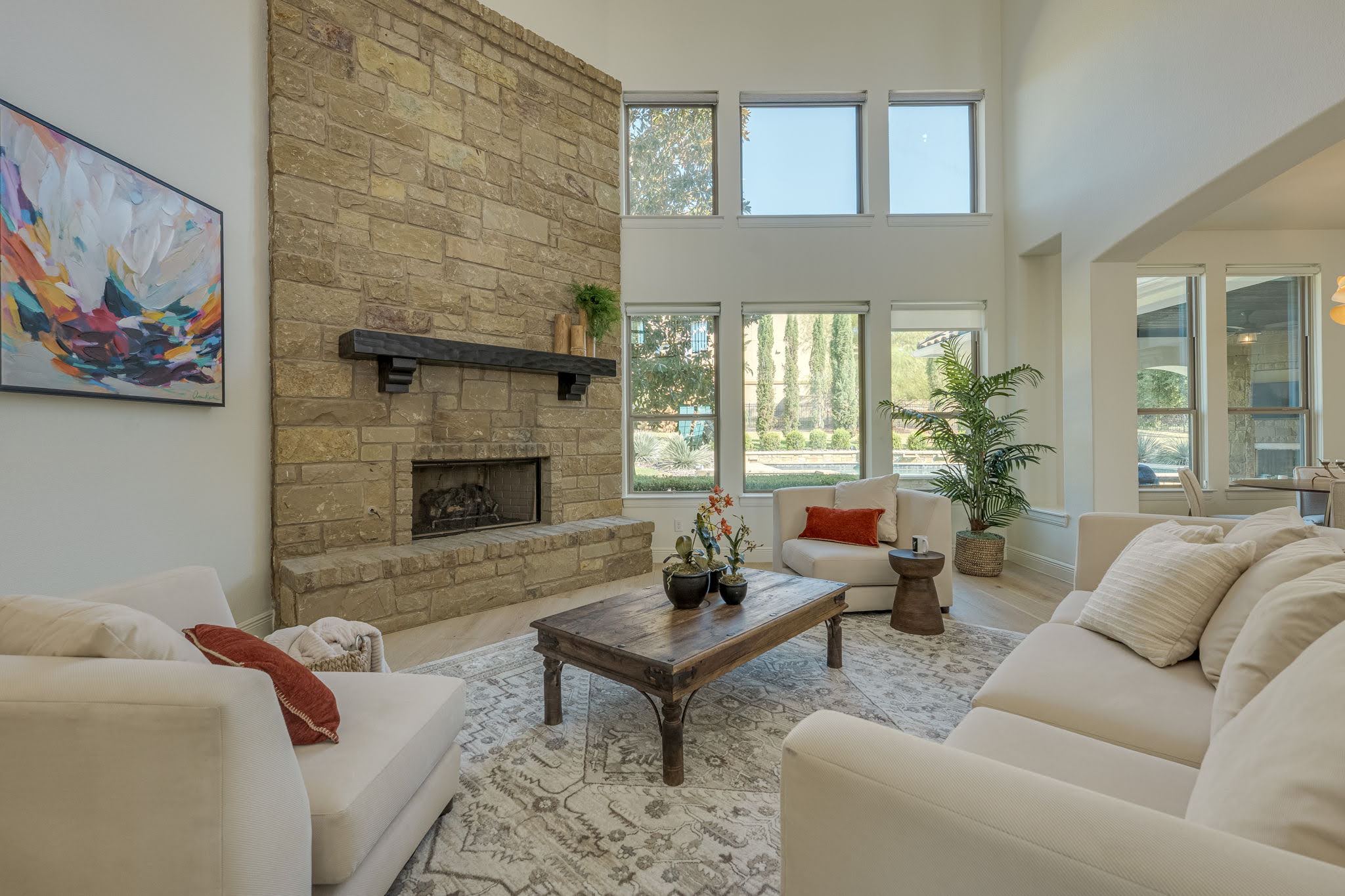 11612 Shoreview Overlook Austin, TX 78732 - Photo 11 of 40 Double-height windows and a towering stone fireplace define this light-filled living area.