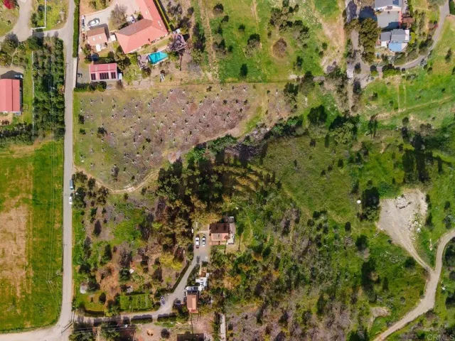 an aerial view of a residential houses with outdoor space