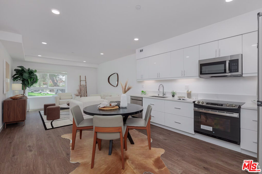 1011 Everett Street, Unit A201 Los Angeles, CA 90026 - Photo 10 of 17 a kitchen with sink cabinets and microwave