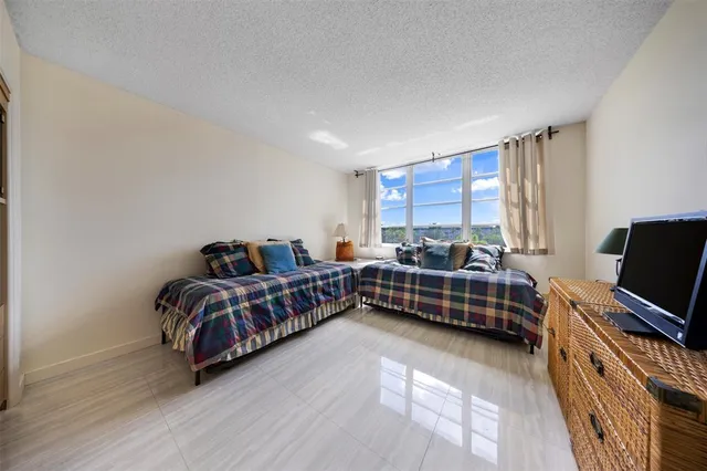 a bathroom with a granite countertop sink mirror and toilet