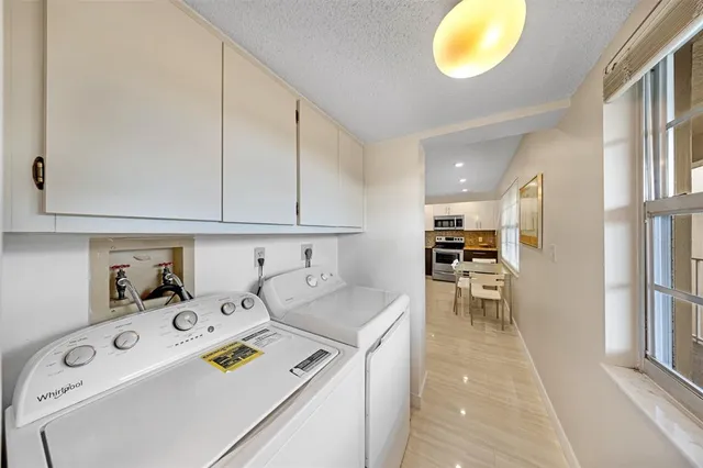 a view of a patio with a table and chairs and potted plants
