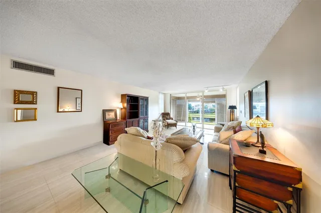 a living room with furniture and a flat screen tv with wooden floor